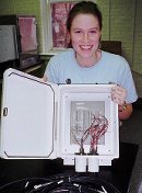 Heather Kordish with the thermistor multiplexor she wired