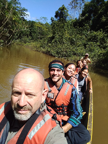 Students in dugout canoe on the Amazon River