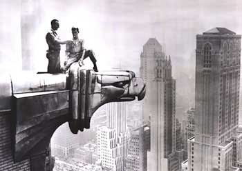 1930s photo of two people sitting high atop the Chrysler Building on an eagle gargoyle